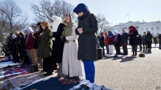 Fatima Chrifi, a teacher at Georgetown University, centre, prays with a group of Muslims and their supporters during Friday prayers outside the White House in Washington, Friday, Feb. 13, 2015, in the wake of the murder of three young North Carolina Muslims.