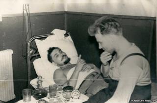 Leonid lying down talking to his friend Yuri Vereschagin