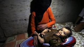 A Yemeni woman and her infant child, forced to flee their family home, due allegedly to ongoing air-strikes carried out by the Saudi-led coalition, take shelter in an underground water tunnel in Sana’a, Yemen, 30 April 2015.