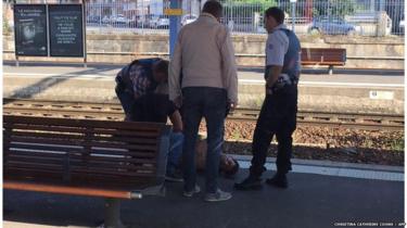 A photo taken by a passenger through the window of a Thalys train shows police detaining a suspect on the platform at the main train station in Arras, northern France, on August 21, 2015,