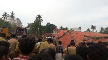 Indian officials and bystanders gather at Puttingal Devi Temple