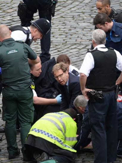 MP Tobias Ellwood helps at the scene of the stabbing of the police officer