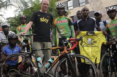 Tour de France champion Chris Froome (C-L) poses for a picture with his mentor David Kinjah (C-R) and Kenyan cyclists of his former racing team, the Safari Simbaz, during a private visit to Nairobi on 19 November 2013