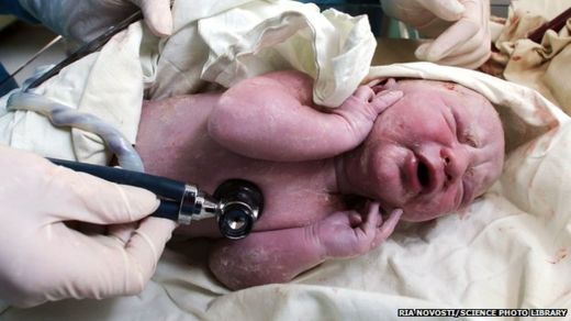 Doctors checking newborn baby