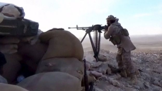 An Islamic State fighter fires a weapon in this still image taken from a video said to be taken on the outskirts of Palmyra and uploaded on March 21, 2016