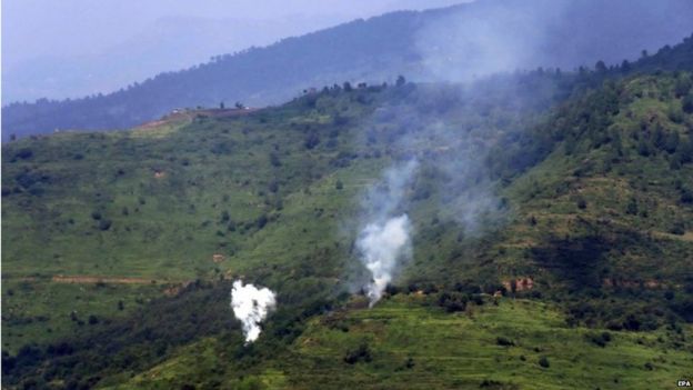 Smoke billows from a mortar shell allegedly fired by the Indian Army from across the Line of Control, at the Nakial sector of Kotli, in Pakistani administered Kashmir, Pakistan, 18 August 2015.