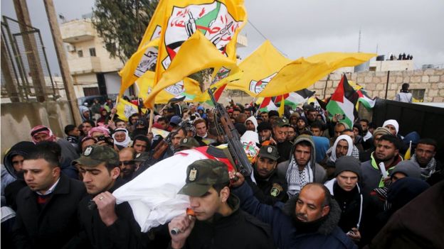 Members of Palestinian security forces carry the body of Palestinian teenager Ruqayya Abu Eid, 13, during her funeral south of Hebron