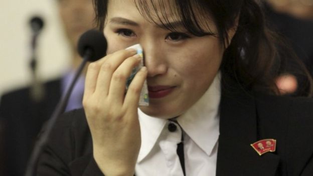 An unidentified colleague of 12 North Korean waitresses who North Korea says was tricked into going to the South wipes her eye as she is presented to the media in Pyongyang, North Korea, Tuesday, May 3, 2016.