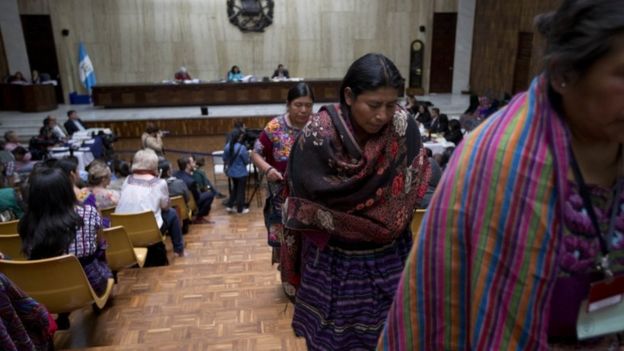 Indigenous women leave the courtroom after watching the first day of hearings for a trial against two former military officers accused of sexual violence during Guatemala's civil war in Guatemala City, Monday, Feb. 1, 2016