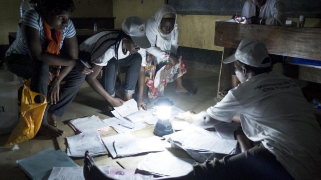 Election workers counting votes by torch lamp in Tanzania - October 2015