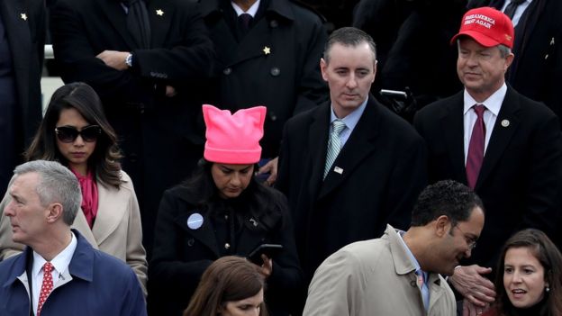 A congresswoman sports a #ProtectOurCare button and a pink pussyhat at the inauguration