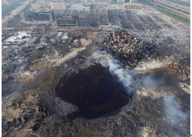 An aerial view on 15 August, 2015, of a large hole in the ground in the aftermath of a huge explosion that rocked the port city of Tianjin, China