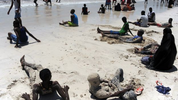 Residents relax on Lido beach on October 31, 2014 along the Indian Ocean's coastal city of Mogadishu