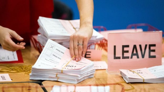 A teller counts ballot papers at the Titanic Exhibition Centre, Belfast