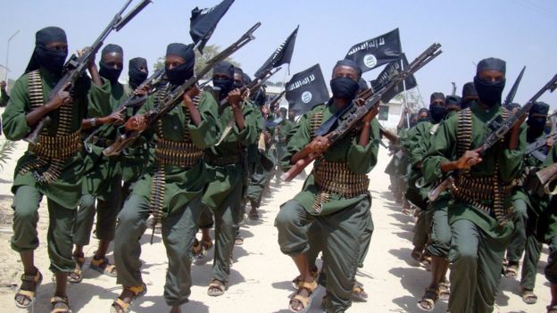 In this Thursday, Feb. 17, 2011 file photo, al-Shabab fighters march with their weapons during military exercises on the outskirts of Mogadishu, Somalia.