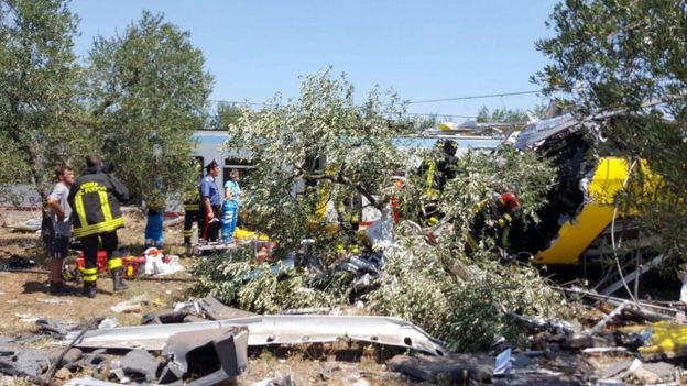 A handout picture provided by the Italian Fire Brigade shows emergency services working at the crash site where two trains collided in southern Italy