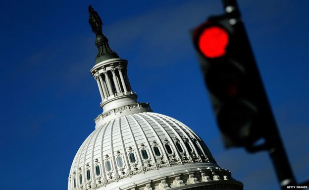 A traffic light is seen in front of the United States Capitol building