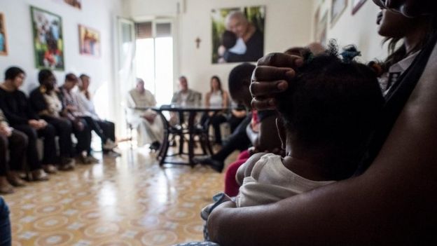 Pope Francis talks to former prostitutes at an apartment for former prostitutes in Rome, Italy