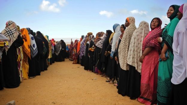 Tanzanian women queue to cast their ballots at a polling station on 25 October2015 in Zanzibar