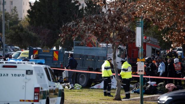 Israeli security forces gather around a flatbed truck at the site of a ramming attack in Jerusalem on January 8, 2017.