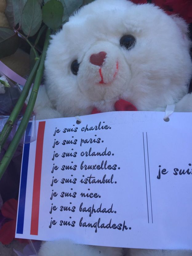 A tribute left by mourners in Nice, France, of a teddy bear holding a sign of solidarity