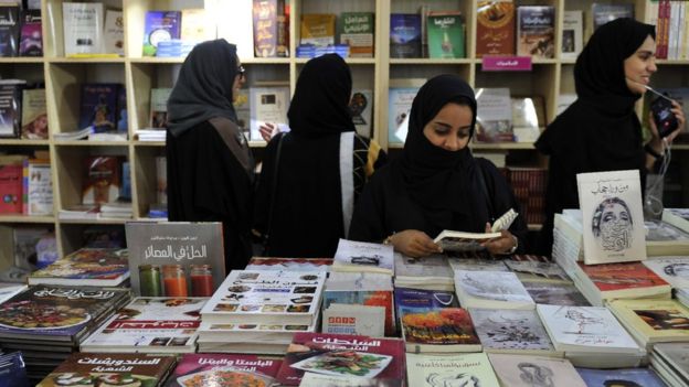Women attend the Jeddah International Book Fair on December 17, 2016 in the Saudi Red Sea port city of Jeddah