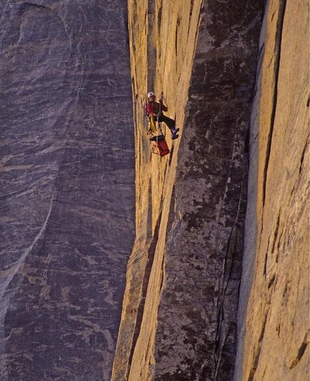 Alex Lowe climbing a rock face