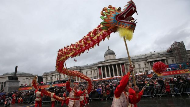 Members of the Chinese community perform a