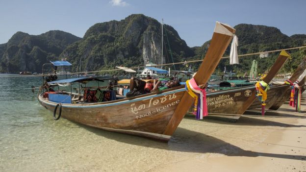 Boats against the backdrop of vegetation-covered mountains on Phi Phi Island in December 2005