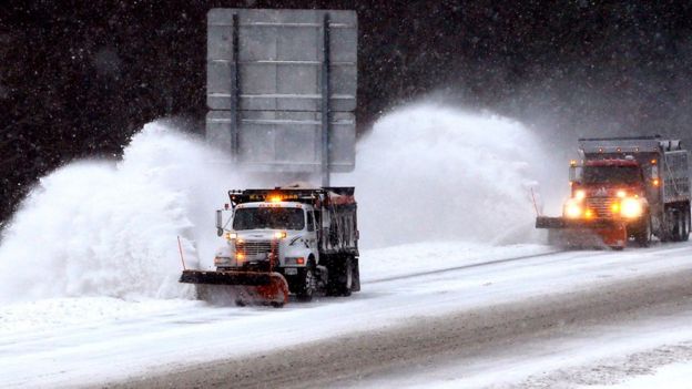 Snow plows clear northbound lanes of Interstate 295 in Hanover County, near Richmond, Va., as snow continues to fall in central Virginia for a second day, Saturday, Jan. 23, 2016