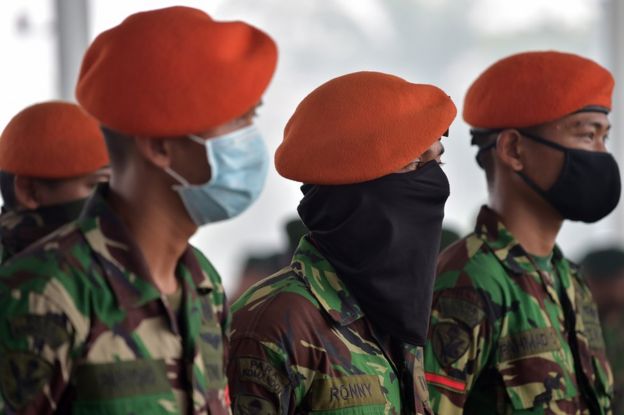 Members of the Indonesia Air Force attend a military roll call at the Roesmin Noejadin Military airport before reinforcing firemen as they combat fires in Pekanbaru, Riau province on 15 September 2015