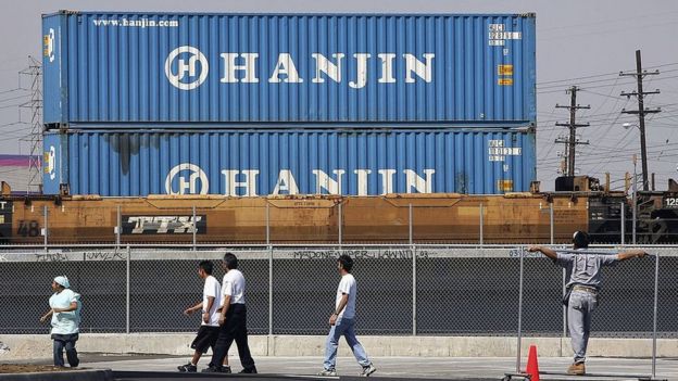 A train carries shipping containers from Hanjin