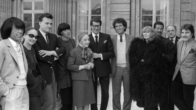 French Minister of Culture Jack Lang (7th left) posing with fashion designers before a lunch organized during the autumn-winter fashion show in Paris. From L to R: Kenzo, Anne-Marie Beretta, Jean-Charles de Castelbajac, Chantal Thomass, Alix Gres, Yves Saint-Laurent, Sonia Rykiel, Issey Miyake, Pierre Berge and Emanuel Ungaro