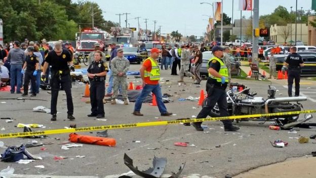 Emergency personnel respond to the scene of an accident after a vehicle crashed into a crowd of spectators during the Oklahoma State University homecoming parade (24 October 2015)