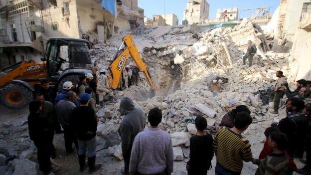 Civil defence members search for survivors after air strikes by in rebel held area of Aleppo, Syria. 14 February 2016.