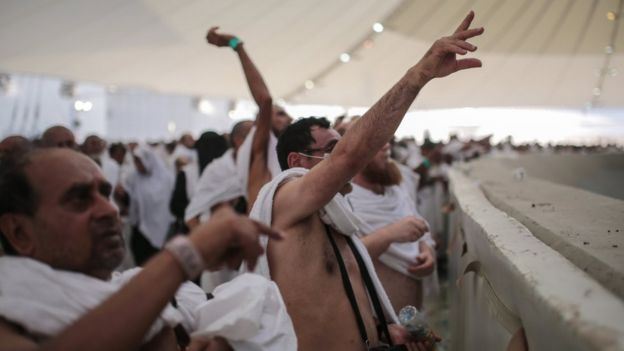 Pilgrims cast stones at a pillar representing the devil - the last major rite of the Hajj, in Mina, Saudi Arabia (24 September 2015)