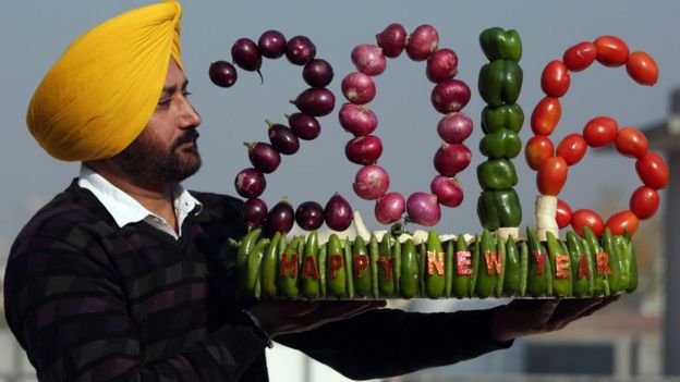 Indian artist Harwinder Singh Gill displays his new vegetable artwork made with vegetables on New Year