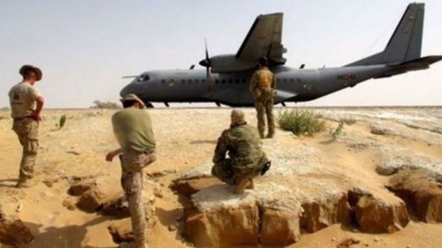 American trainers and Chadian soldiers next to a military plane