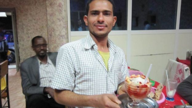 A waiter serving a desert at a restaurant in Hargeisa, Somaliland