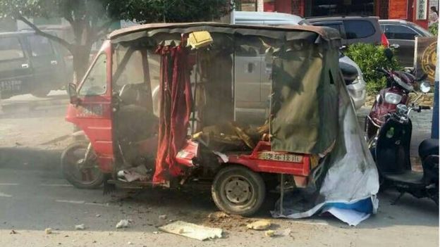 A vehicle is seen damaged after explosions hit Liucheng county, Guangxi Zhuang Autonomous Region, China, 30 September 2015