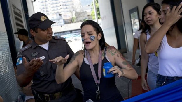 Relatives of military police members block an entrance in an attempt to impede officers from going to work at a military police in Rio de Janeiro, Brazil, Friday, Feb 10, 2017.