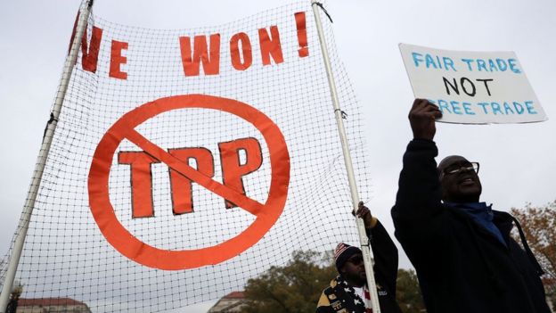 Activists shout slogans as they march during an anti-Trump and anti-TPP protest November 14, 2016 in Washington, DC. Activists held a rally and a march