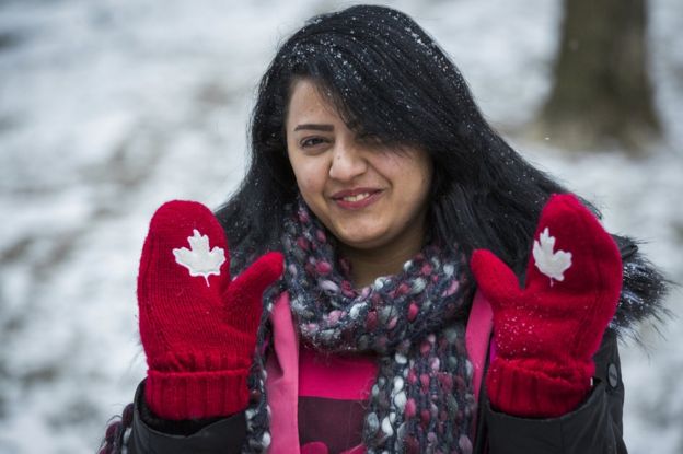 Syrian refugee Rania Alhasan smiles and holds up her Canadian themed mittens in Mississauga, Ontario, Canada, Thursday January 21, 2016.