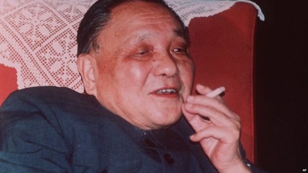 Chinese leader Deng Xiaoping smokes a cigarette