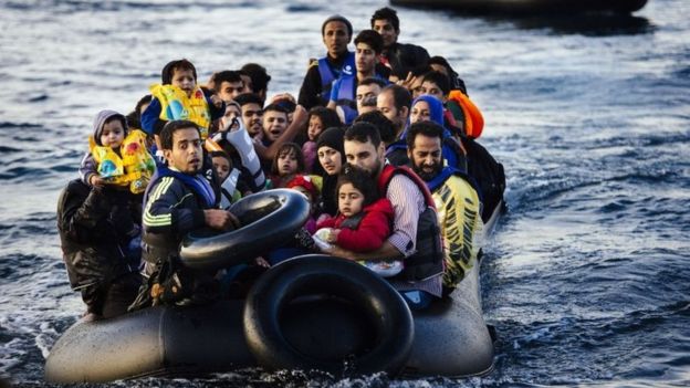 Migrants and refugees arrive on a dinghy on the Greek island of Lesbos, after crossing the Aegean sea from Turkey, on October 14, 2015
