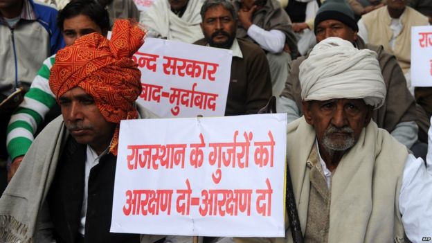 Indian Gujjar community members hold anti-government placards during a demonstration against the Congress-led UPA and Rajasthan governments in New Delhi on December 31, 2010.