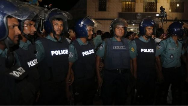 Police officers stand guard outside Dhaka's prison