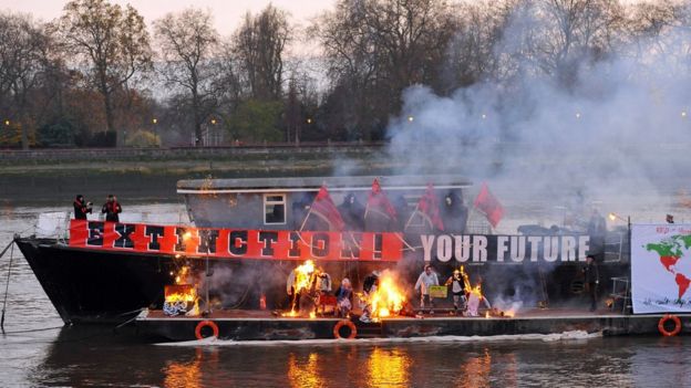 A boat with burning memorabilia on the river thames