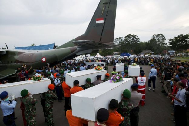 Caskets containing the remains of AirAsia QZ8501 passengers recovered from the sea are carried to a military transport plane before being transported to Surabaya, where the flight originated, at the airport in Pangkalan Bun, Central Kalimantan in this 2 January 2015 file photo