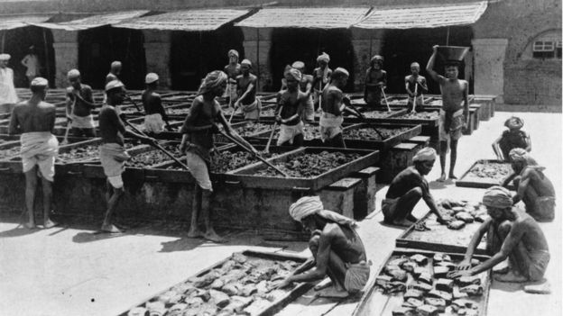 Indian workers making opium